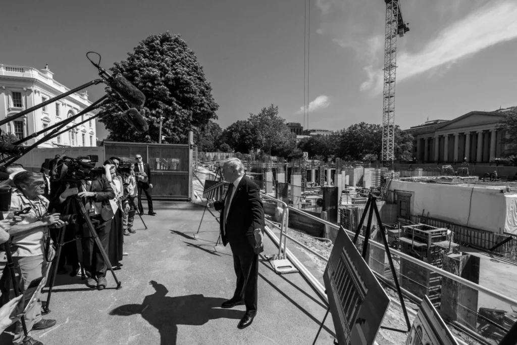 President Donald Trump speaks with reporters beside East Wing and ballroom construction at the White House on May 19, 2026. Official White House photo by Joyce N. Boghosian.